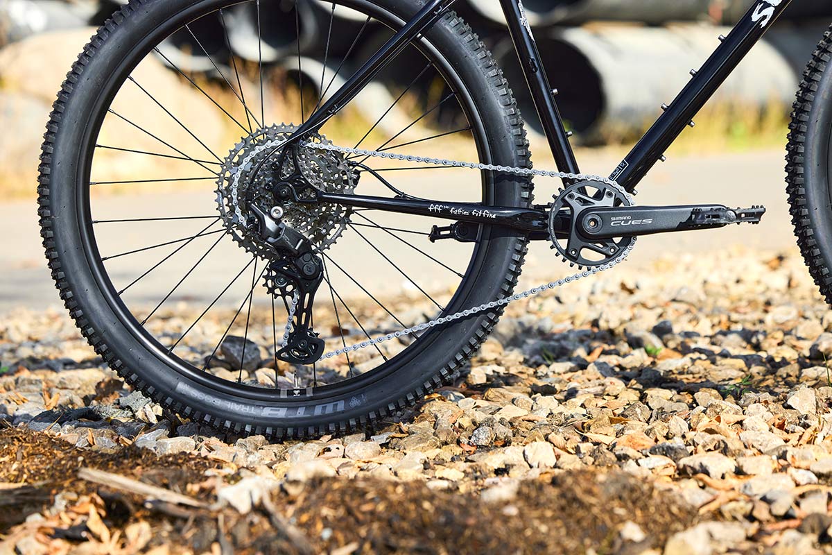 Surly Bridge Club detail focusing on rear wheel and drivetrain on gravel