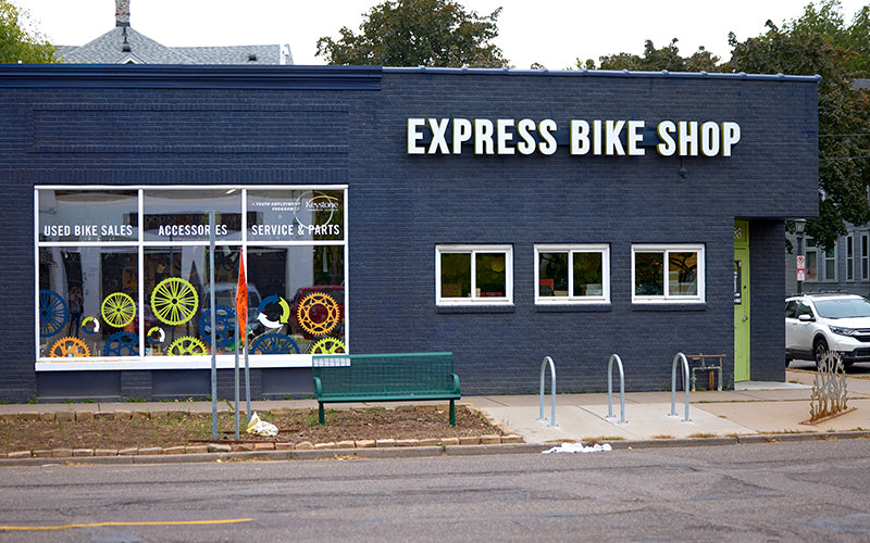 Express Bike Shop building with bicycle wheels displayed in the window