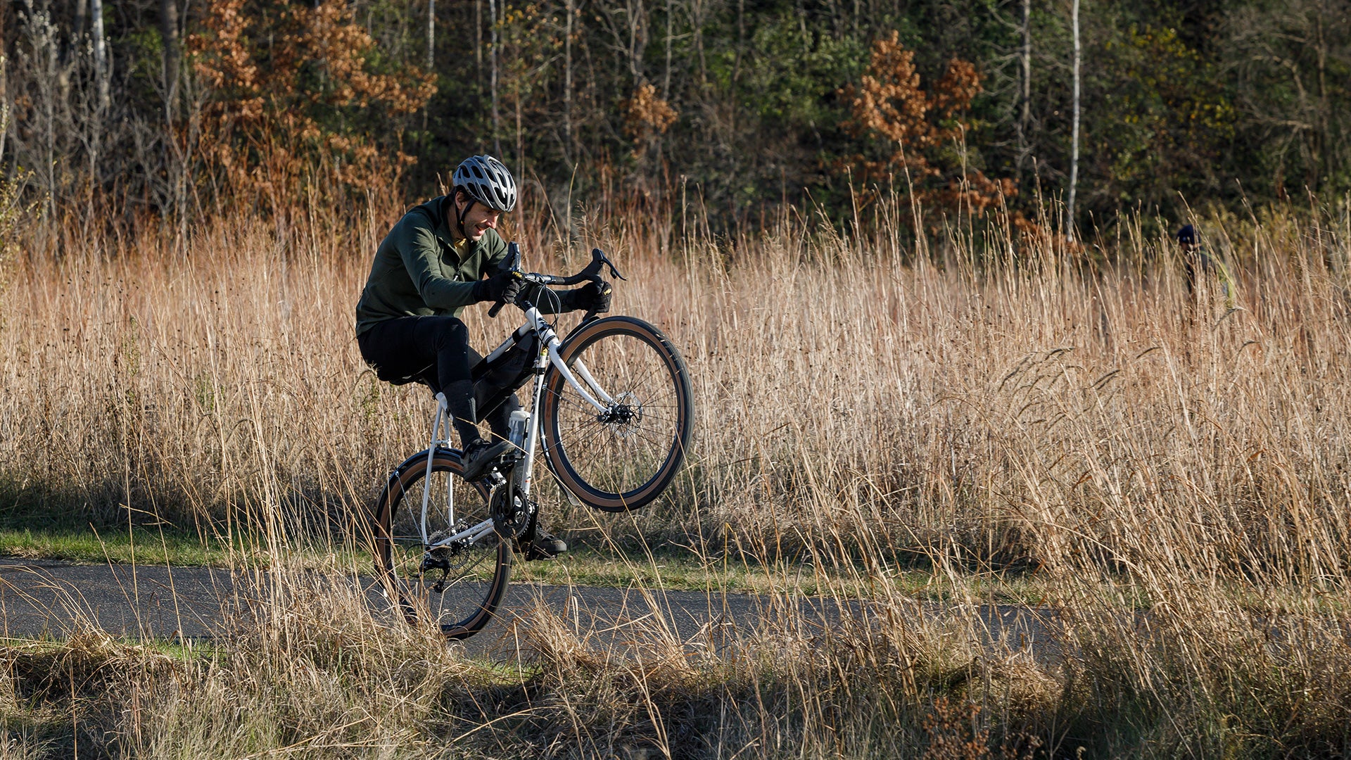 Cyclist riding wheelie on drop bar Surly Midnight Special