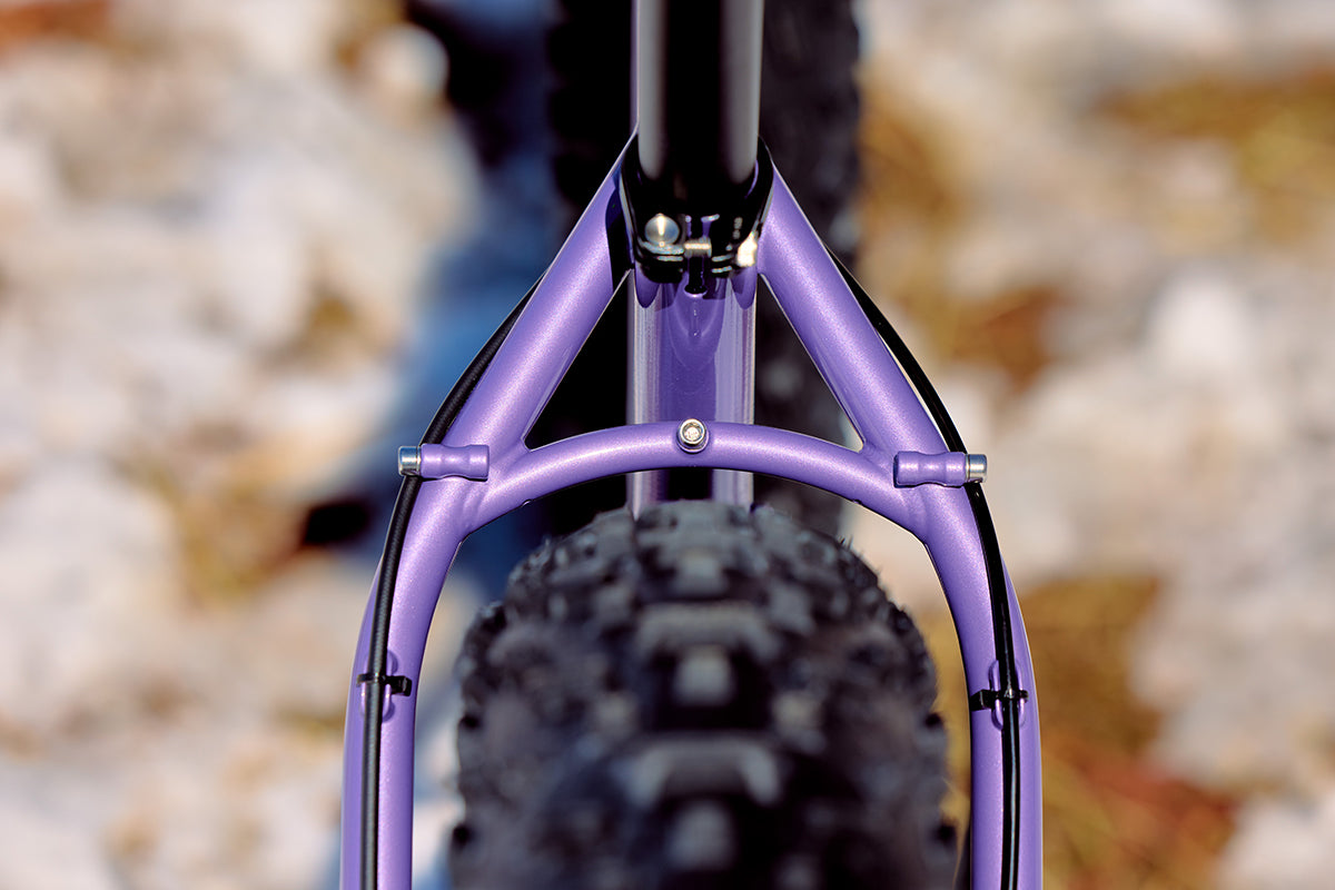 Surly Ice Cream Truck in purple color focus on rear frame tire clearance and rack mounts
