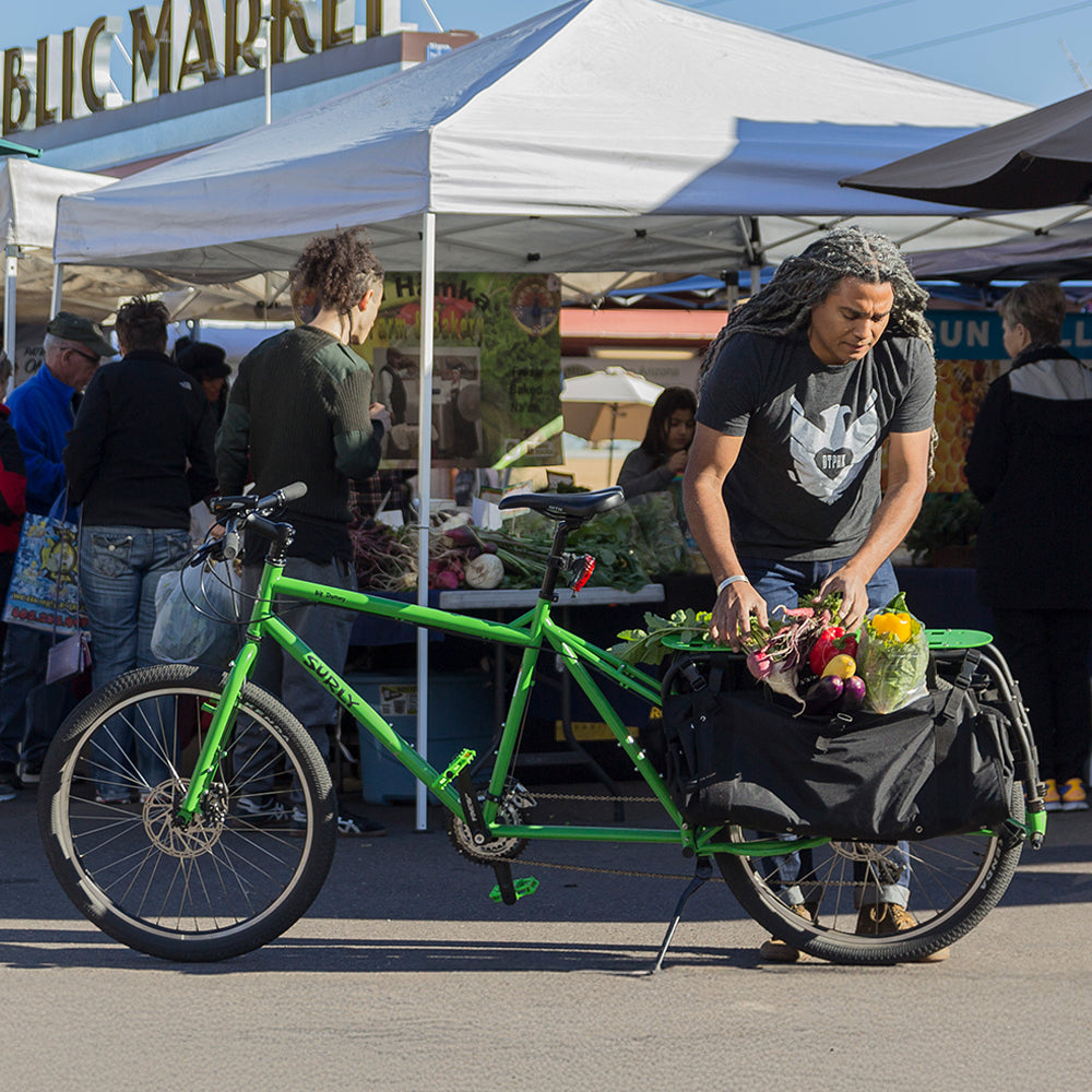 Person loading farmers market goodies onto Surly Big Dummy
